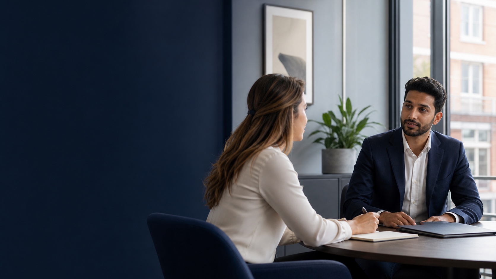 Two professionals discussing a career opportunity in a modern office